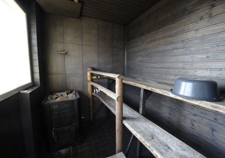 Helsinki: RIB Tour to Local's Cottage with BBQ and Sauna - Heating the wood-fired sauna