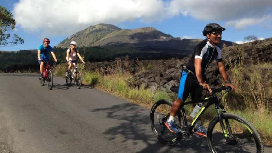 Mount Batur: Black Lava Cycling Tour w/ Natural Hot Spring - Lake Batur, the temple, and the local side of Bali
